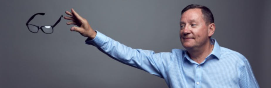 Happy man throwing away glasses after successful LASIK surgery – Soroudi Advanced LASIK & Eye Centers Los Angeles 